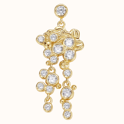 Ørering med et stik. på Ørestikken sidder en zirconiasten omkranser af en guld belægning. Øreringen har et stor vedhæng som er en blandet af guld og zirconiasten der sidder asymmetrisk. på det store vedhænd er der yderligere to vedhæng der falder ned fra med en blanding af guld kugler og zirconiasten 